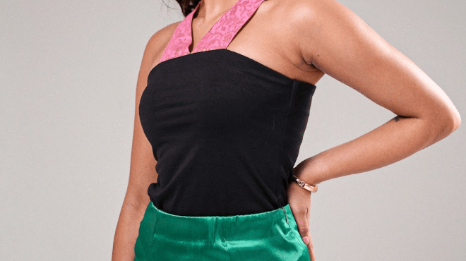 woman in a green skirt and black and pink top