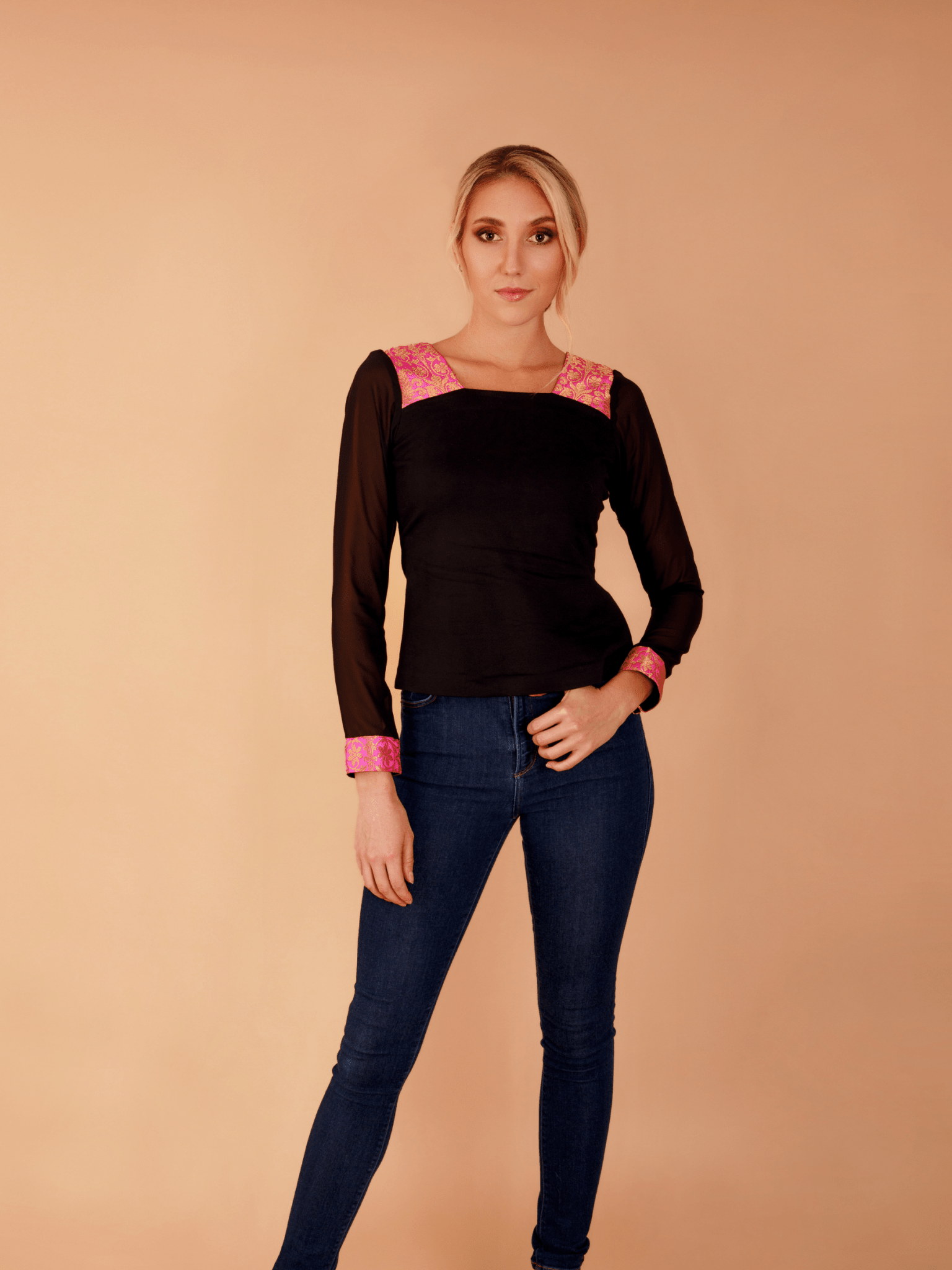 Front view of the long-sleeve Dolce Top showcasing its textured fabric, elegant neckline, and hand-finished accents.