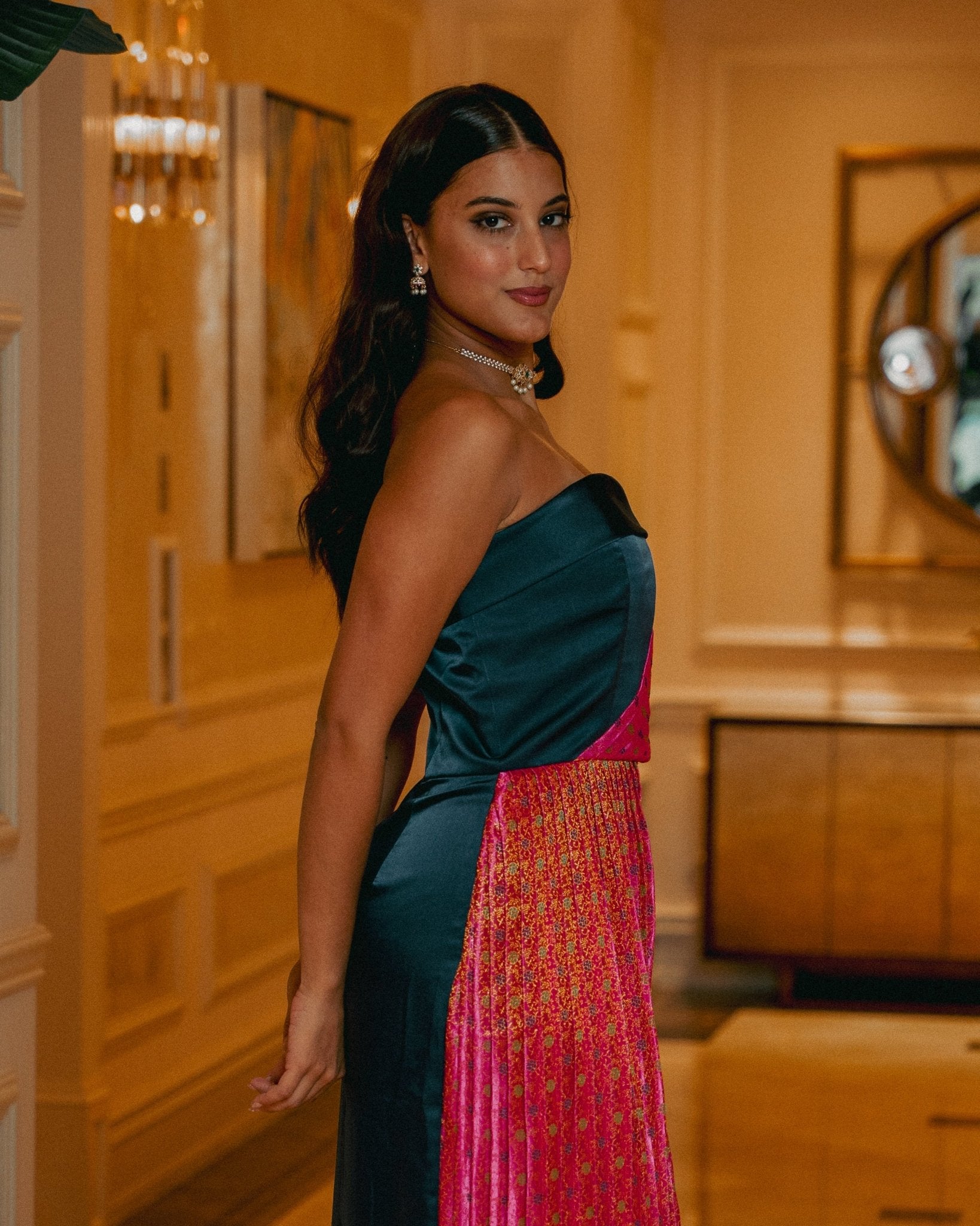 side view of woman in blue and pink dress