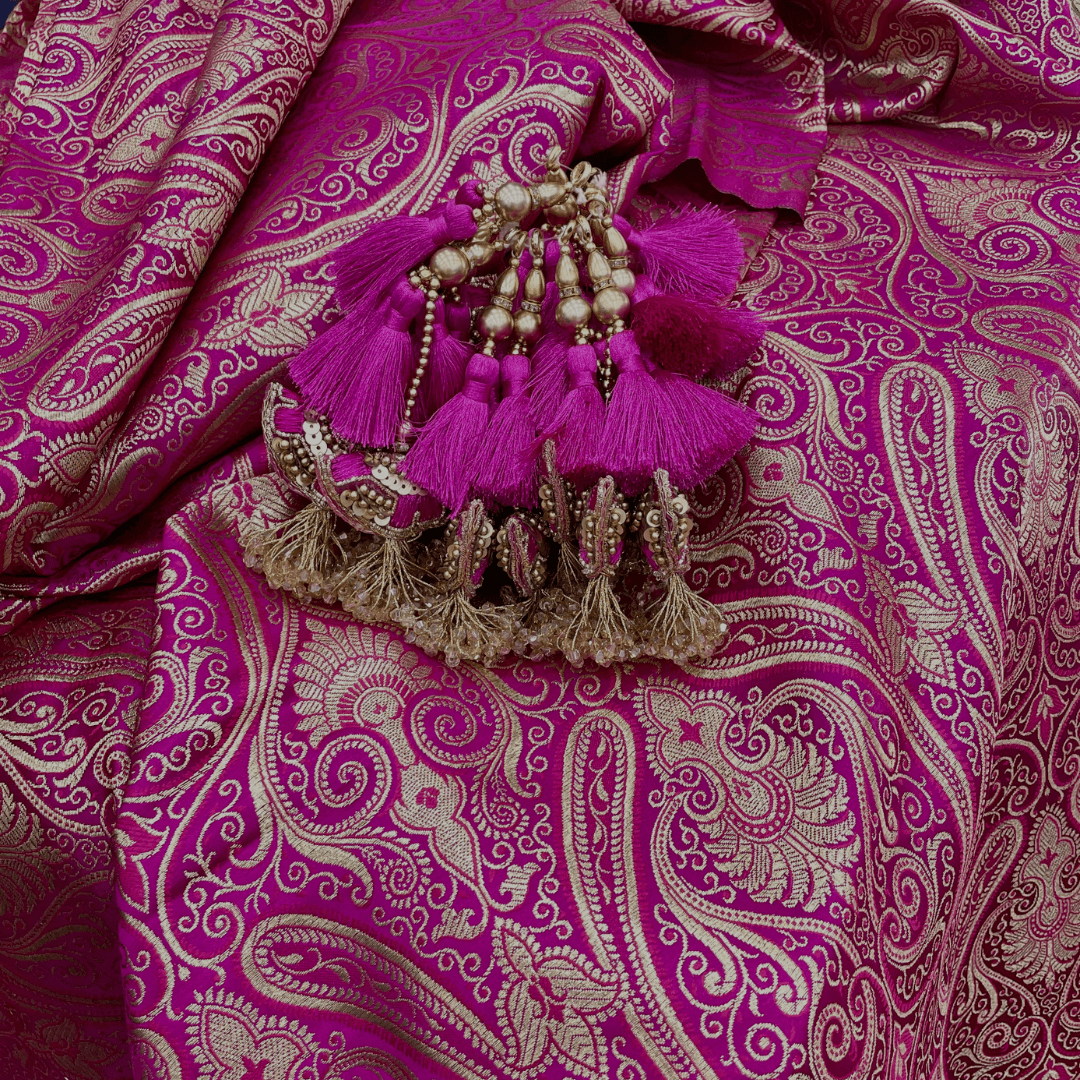 Pink Indian textile with a pink and gold tassel 