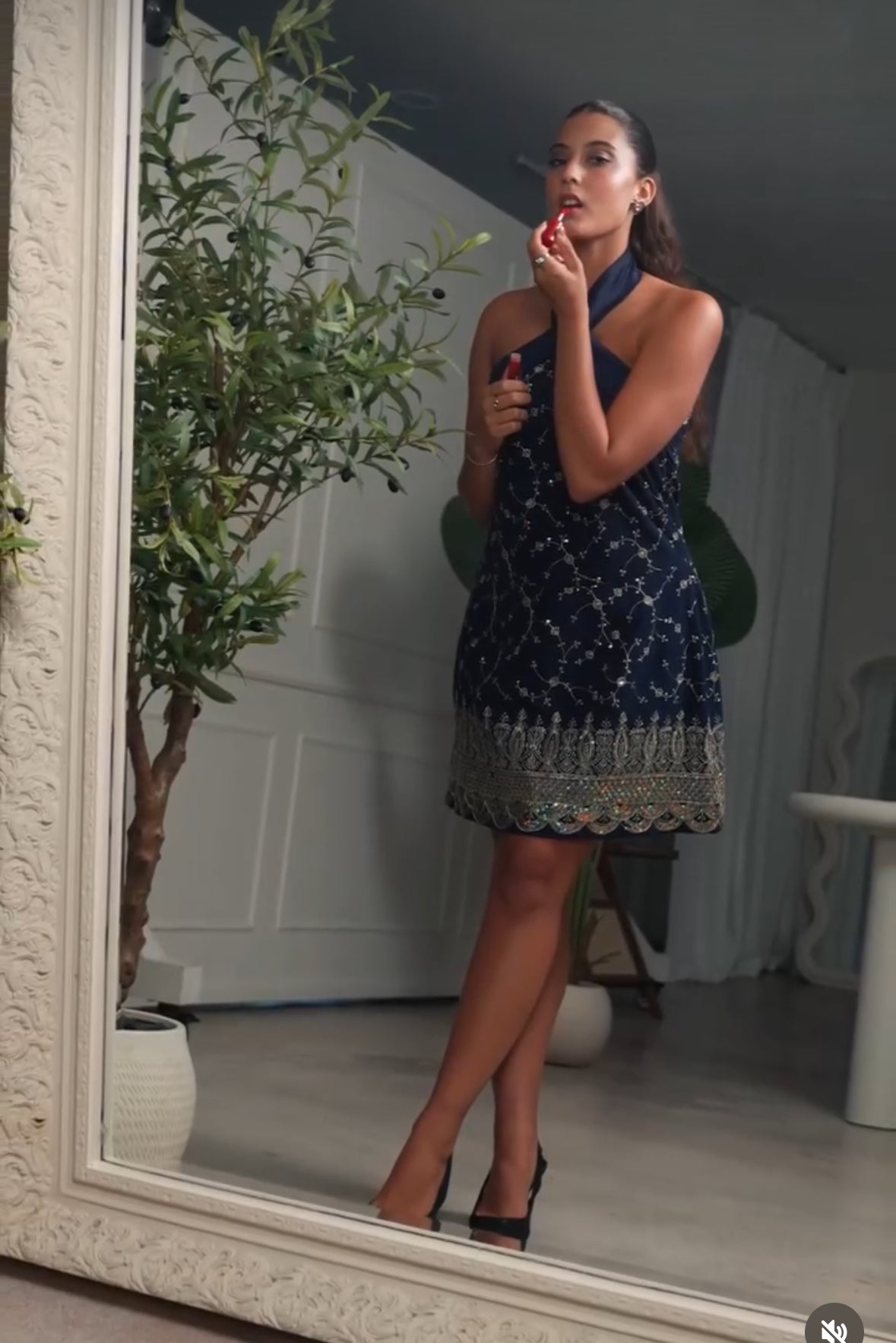 woman putting lipstick on