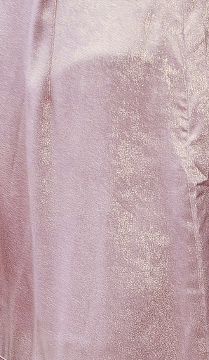 Close-up of a textured fabric with a gradient of colors and gold accents.