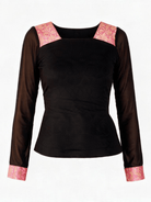 A black long-sleeve top with sheer mesh sleeves and contrasting pink paisley patterned trim at the square neckline and cuffs, shown against a plain white background.