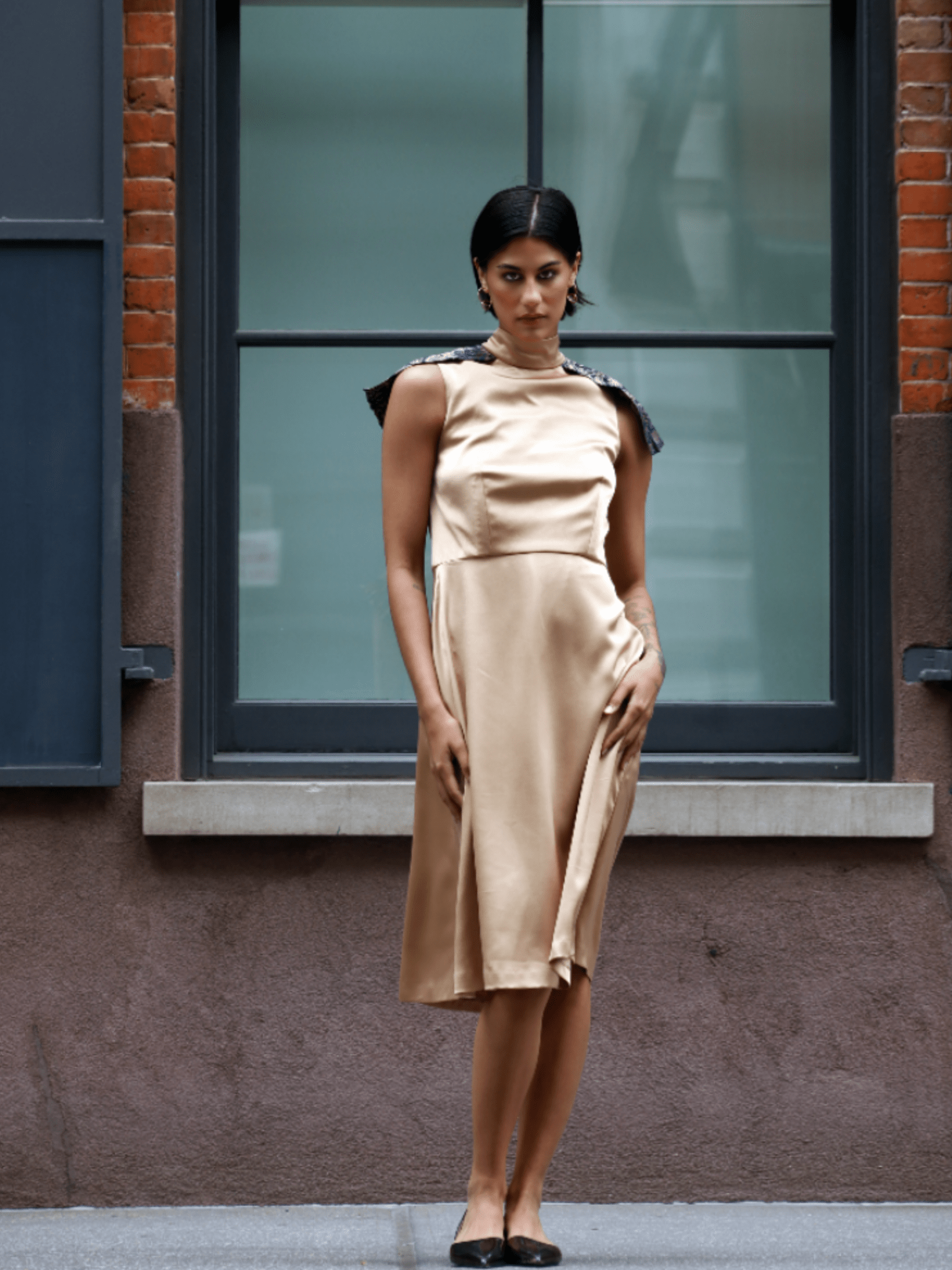 Full-length view of the gold Vivanna dress, capturing its warm metallic tone, fluid movement, and artisanal craftsmanship