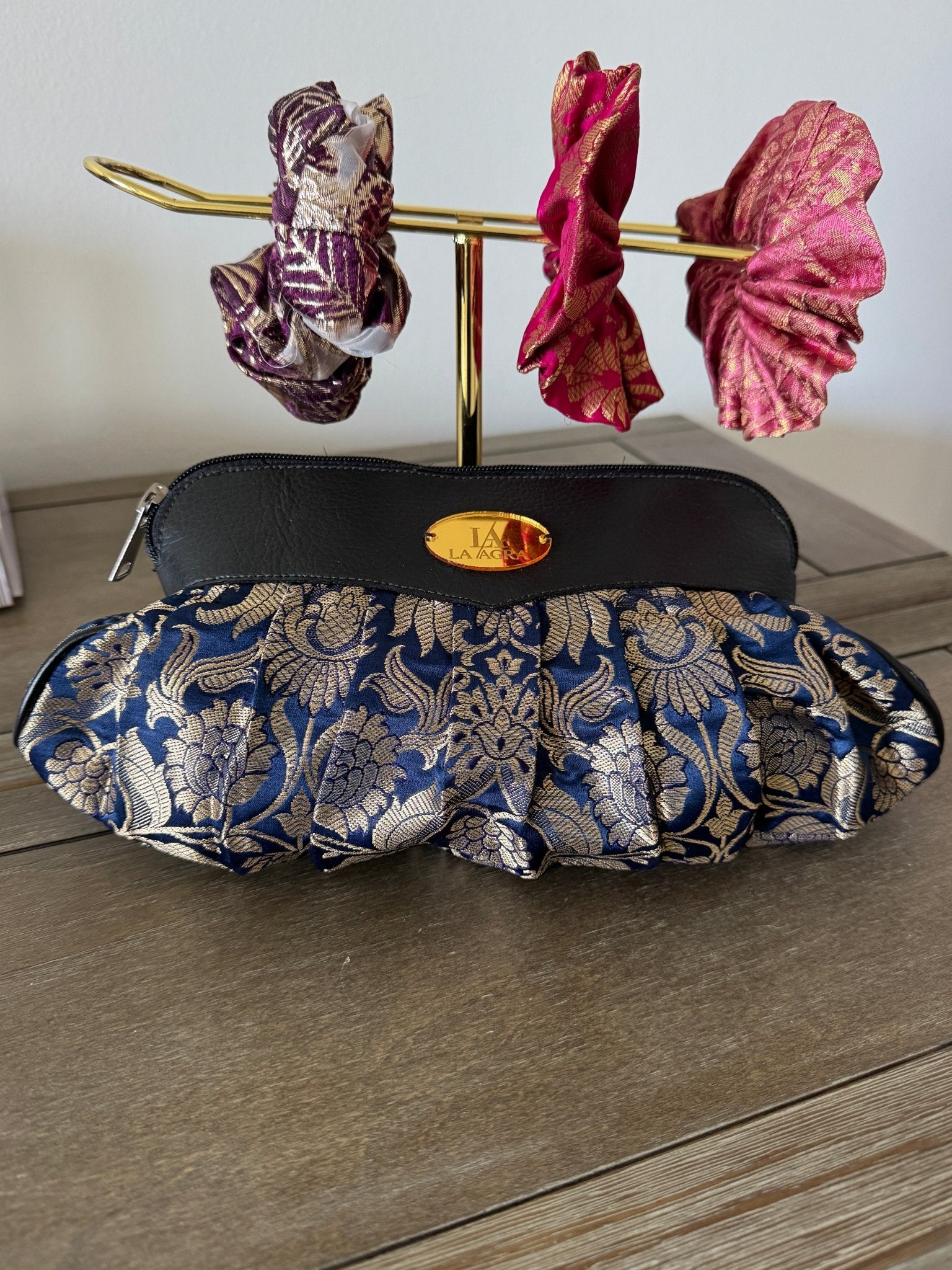 Blue floral-patterned shoe cover on a wooden surface with decorative flowers.