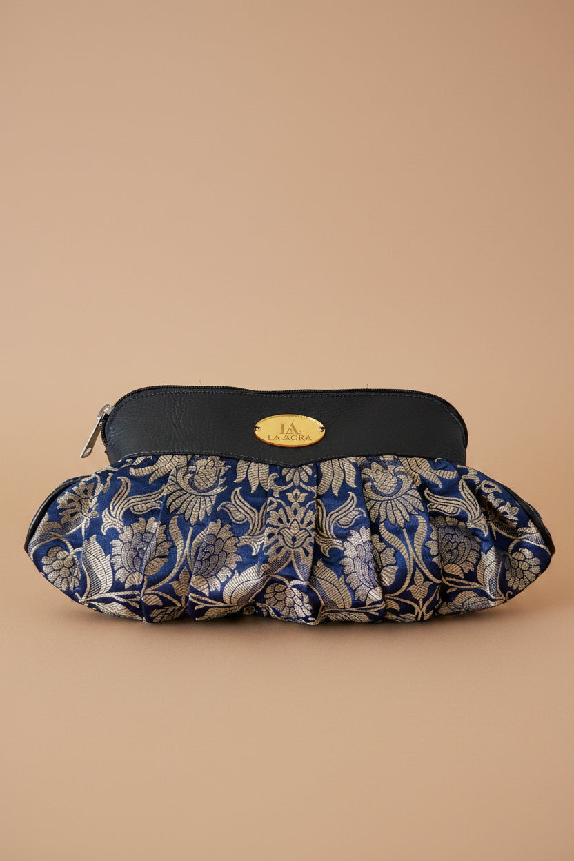 Blue floral-patterned shoe cover on a wooden surface with decorative flowers.