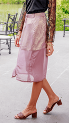 Person wearing a Lilac skirt with a blurred outdoor background