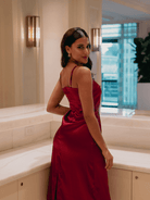 Woman in a red dress standing in a modern interior setting