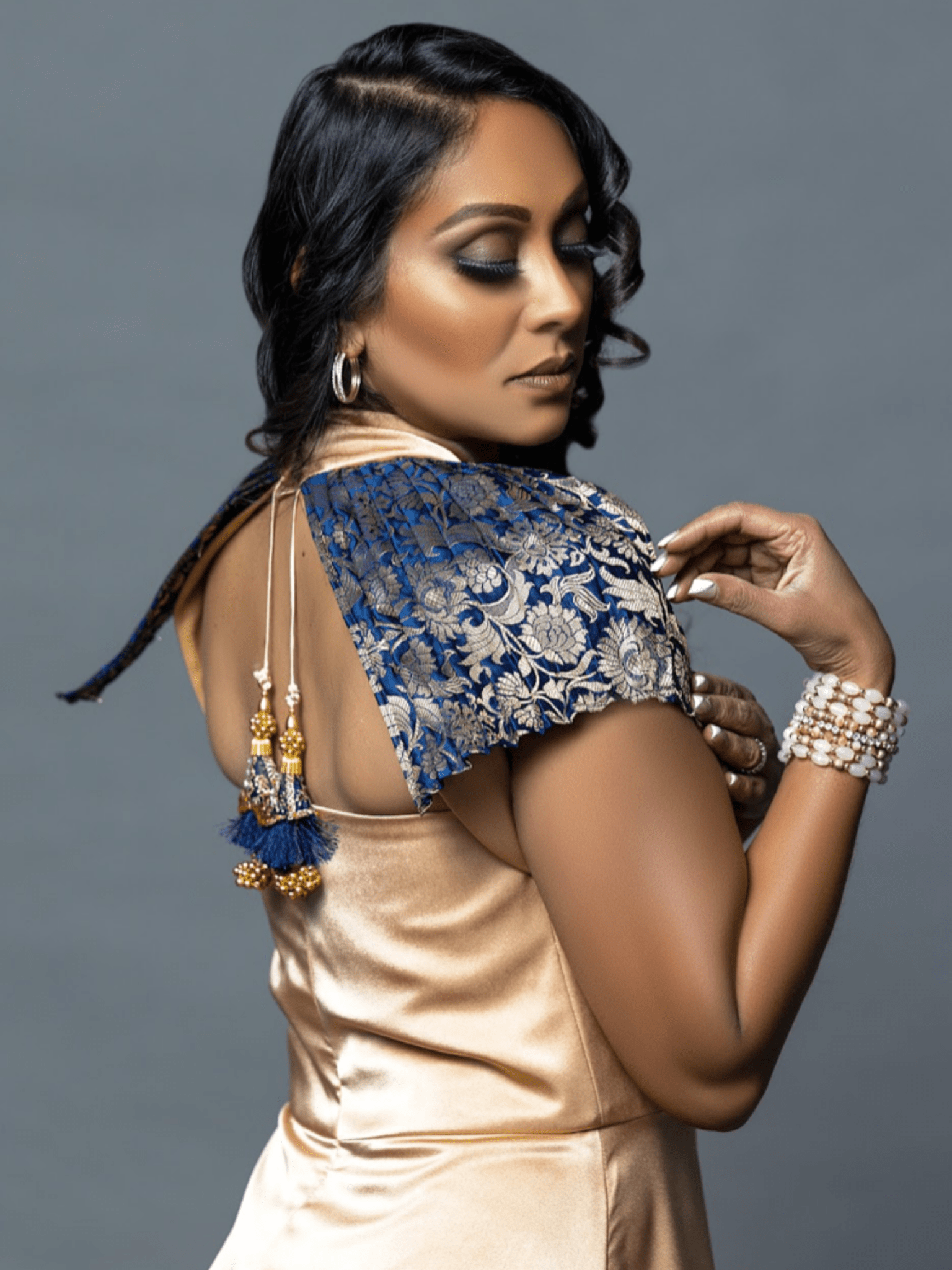 Model wearing the gold Vivanna dress, a luminous, heritage-inspired dress with intricate detailing and an elegant, contemporary fit.