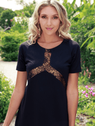 Woman wearing a black dress with lace details outdoors